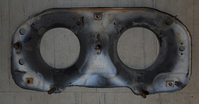 HEADLIGHT BACKING PLATE, LEFT SIDE, USED